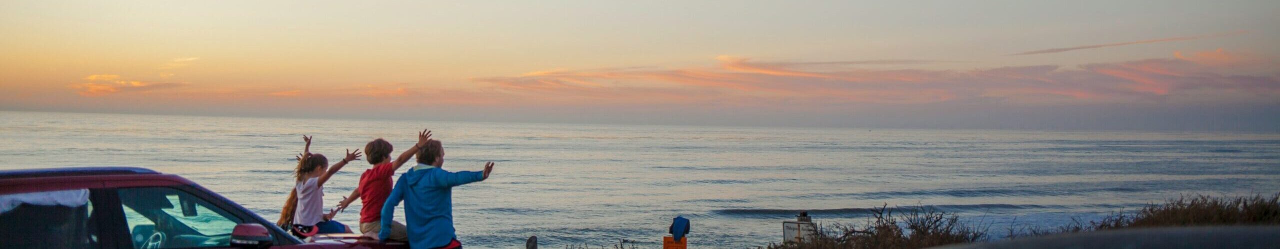 Family watching sunset over california coast